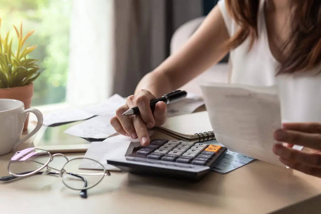 woman checking bills, taxes, bank account balance